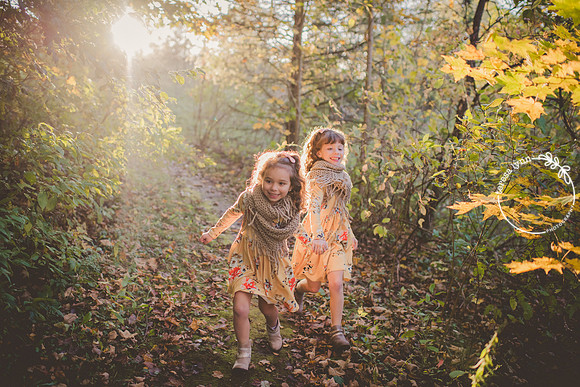 Sisters running through forest